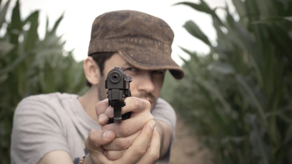 A Man Pointing A Gun