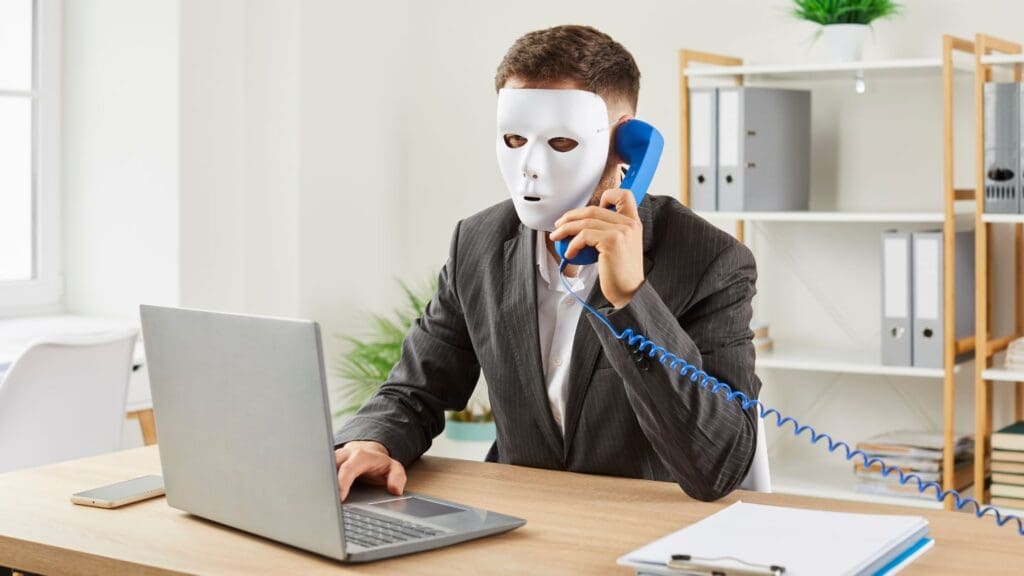 Masked Office Worker Engaged in Phone Conversation