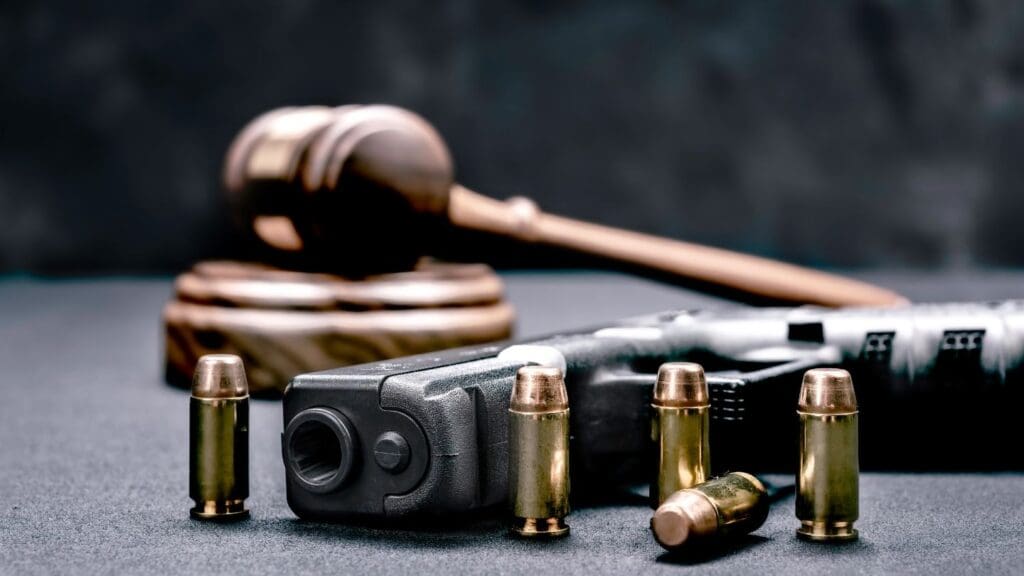 Pistol with Bullets and Wooden Gavel